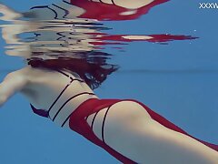 Small Russian Marfa swims bare in the pool