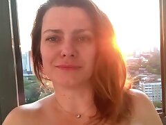 Kinky MILF shakes her ass on the balcony, fucks herself with a dildo, squir