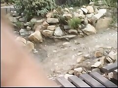 Black-haired man screws a teenie blonde's taut donk at camp